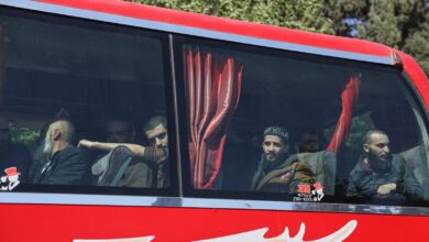 Syrian government and Kurdish-led force exchange prisoners in a step toward easing tensions