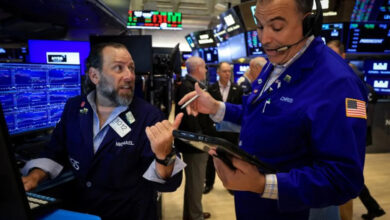 Stocks edge lower as dollar rises to one-year high